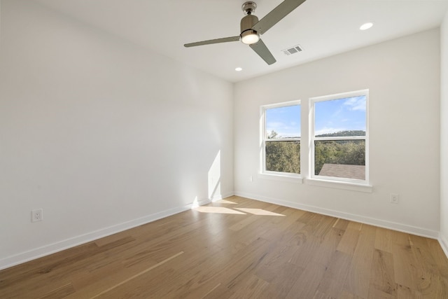 spare room with ceiling fan and light hardwood / wood-style floors