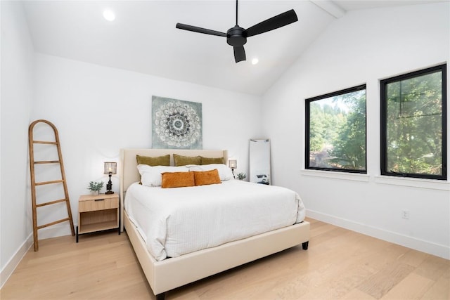 bedroom featuring ceiling fan, lofted ceiling with beams, and light wood-type flooring