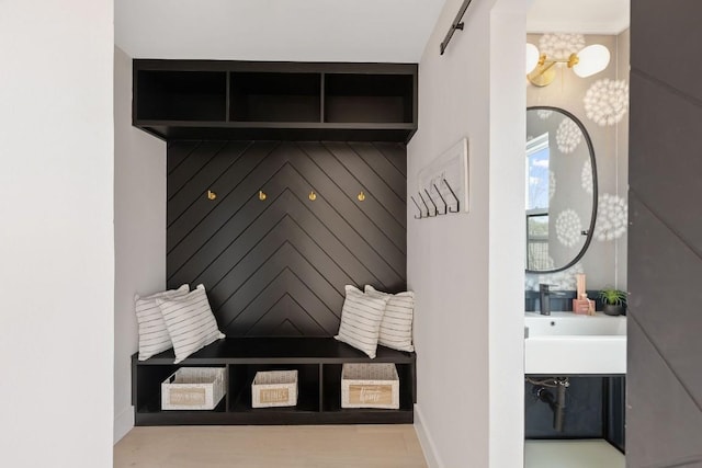 mudroom featuring a barn door and sink