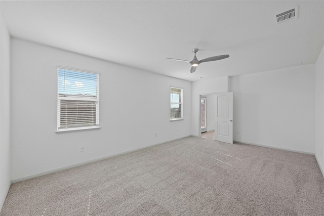 carpeted empty room with ceiling fan