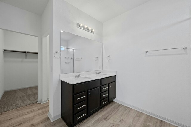 bathroom with vanity, wood-type flooring, and an enclosed shower