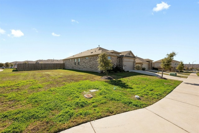 view of side of home featuring a lawn and a garage