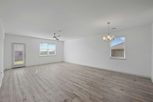 spare room with light hardwood / wood-style floors and ceiling fan with notable chandelier