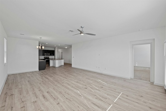 unfurnished living room with ceiling fan with notable chandelier and light wood-type flooring