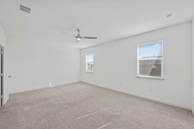 empty room with ceiling fan and carpet floors