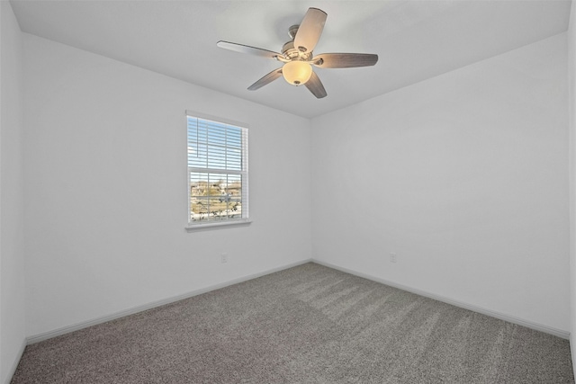 unfurnished room with ceiling fan and carpet