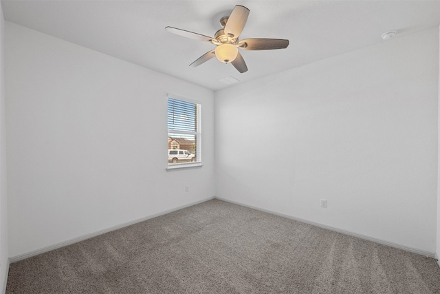 carpeted spare room with ceiling fan