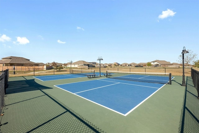 view of tennis court with basketball hoop