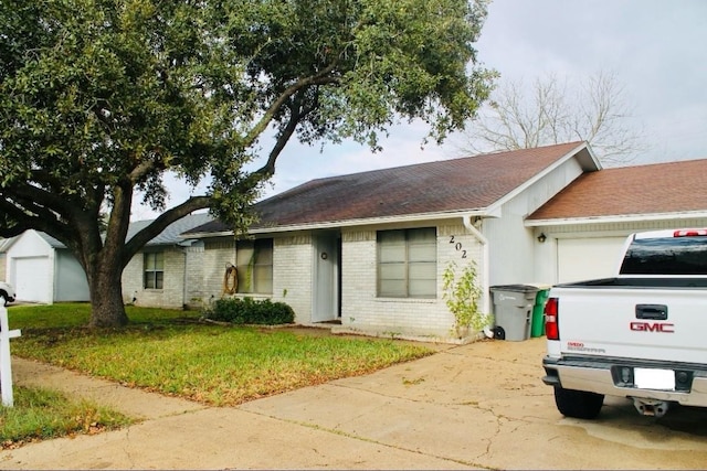 single story home featuring a front yard and a garage