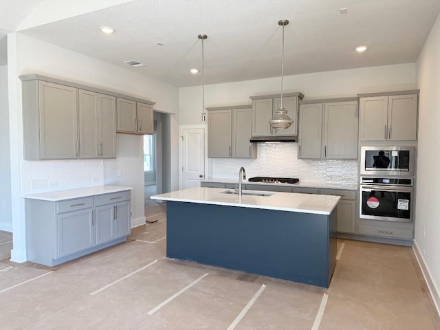 kitchen featuring visible vents, gray cabinetry, a sink, backsplash, and stainless steel appliances