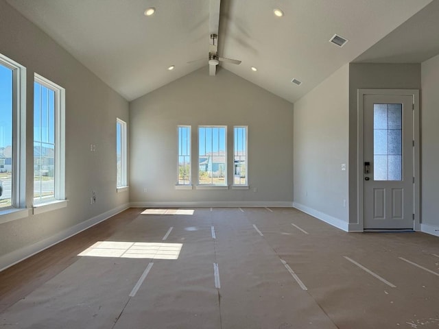 unfurnished living room with visible vents, high vaulted ceiling, and baseboards