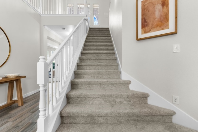 stairway with hardwood / wood-style floors