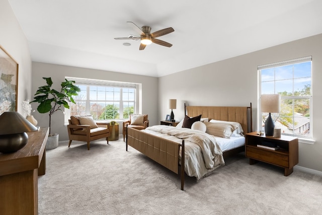 bedroom featuring multiple windows, light carpet, and ceiling fan