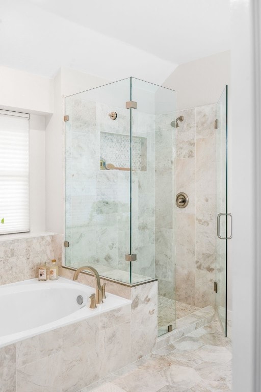 bathroom with separate shower and tub and vaulted ceiling