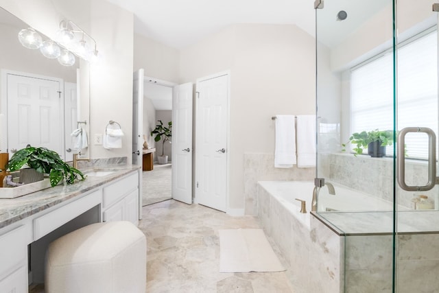 bathroom featuring plus walk in shower, vanity, and vaulted ceiling