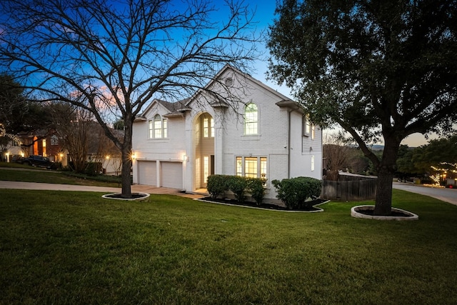 front of property with a lawn and a garage