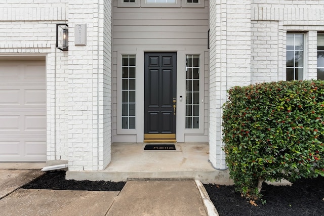 view of exterior entry with a garage