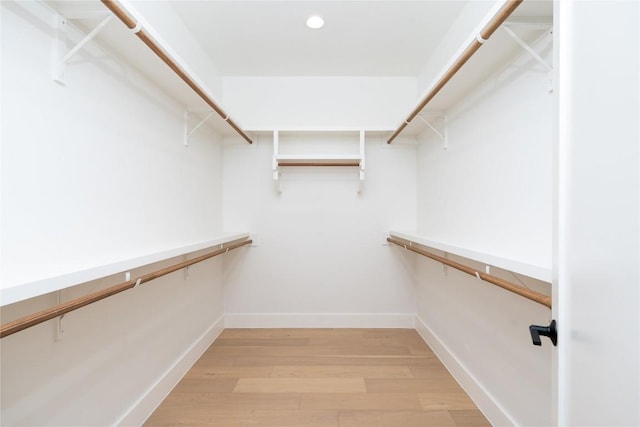 walk in closet with hardwood / wood-style floors