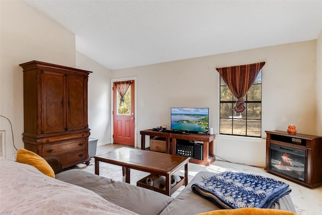 living room featuring a wealth of natural light and lofted ceiling