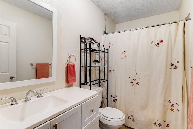 bathroom featuring vanity, a textured ceiling, and toilet