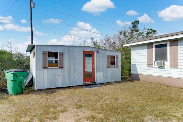 view of outbuilding with a yard and cooling unit