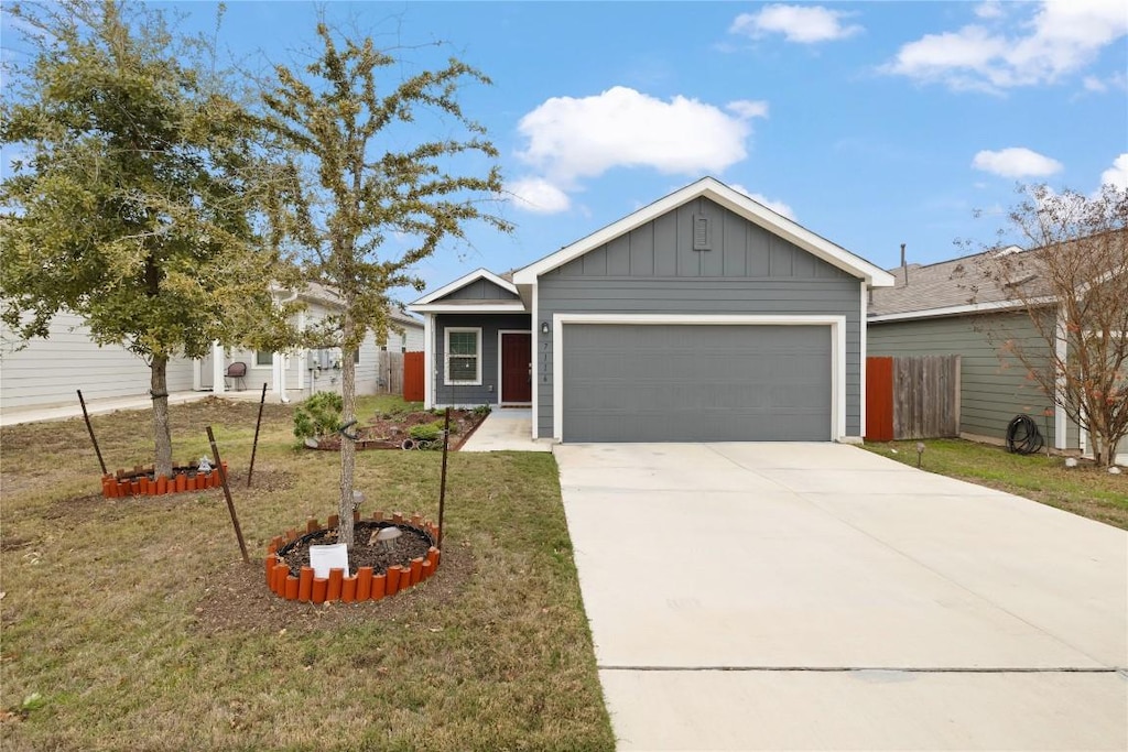 view of front of property featuring a front lawn and a garage