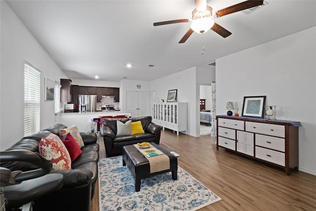 living room with hardwood / wood-style floors and ceiling fan