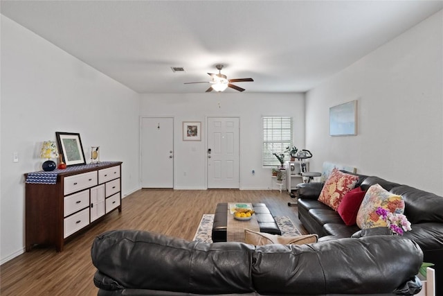 living room with hardwood / wood-style flooring and ceiling fan