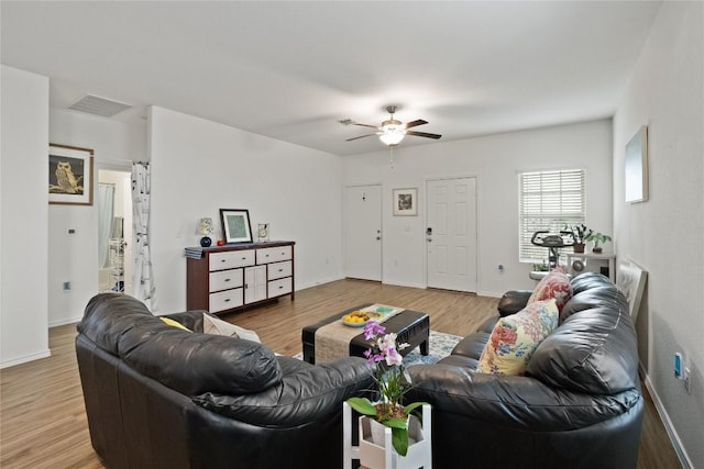 living room featuring ceiling fan and hardwood / wood-style floors