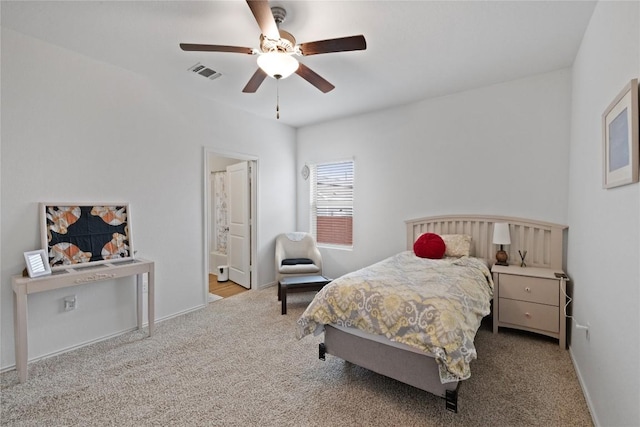 carpeted bedroom featuring ensuite bath and ceiling fan