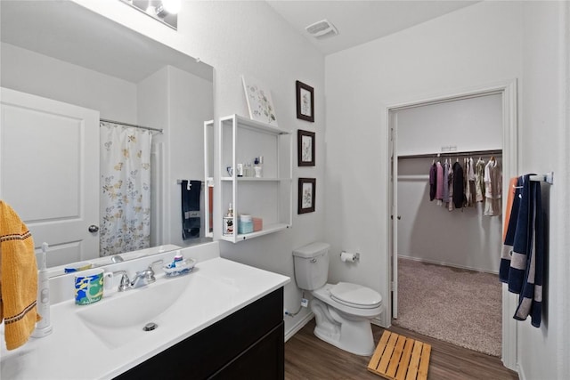 bathroom featuring vanity, toilet, and wood-type flooring