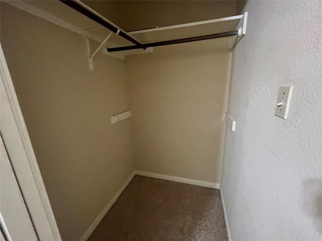 walk in closet with carpet