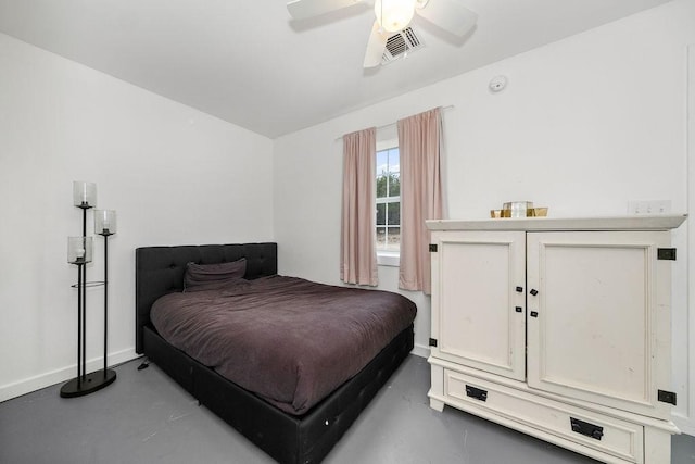 bedroom with ceiling fan and concrete floors