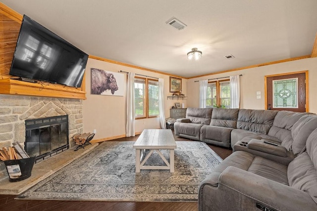 living room with a fireplace, hardwood / wood-style flooring, and crown molding