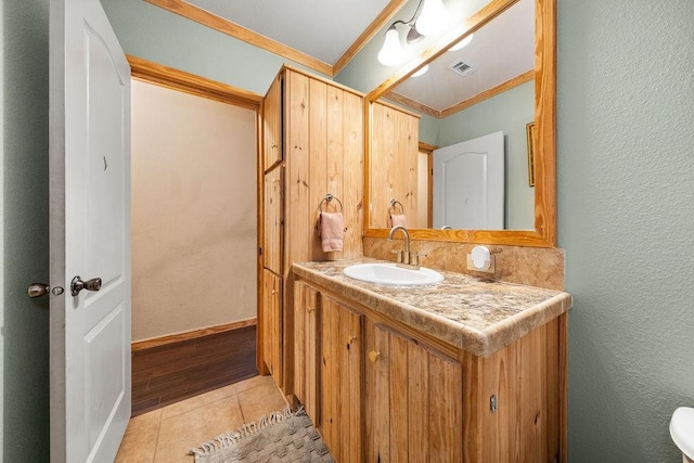 bathroom with vanity, tile patterned floors, and ornamental molding