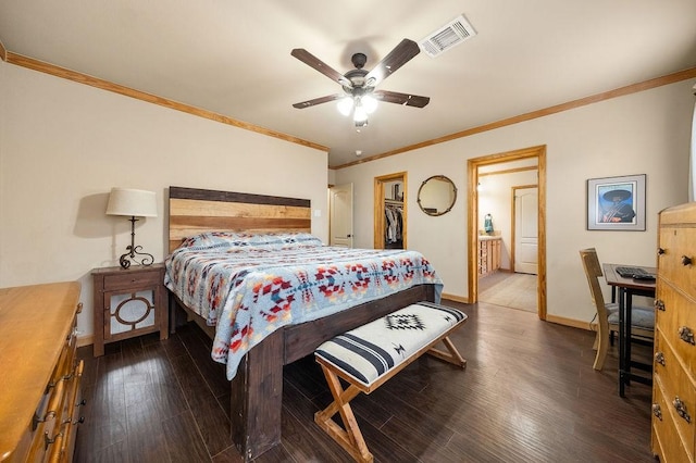 bedroom with ceiling fan, dark hardwood / wood-style floors, ornamental molding, and a closet