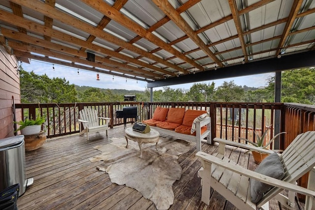 wooden terrace with an outdoor hangout area