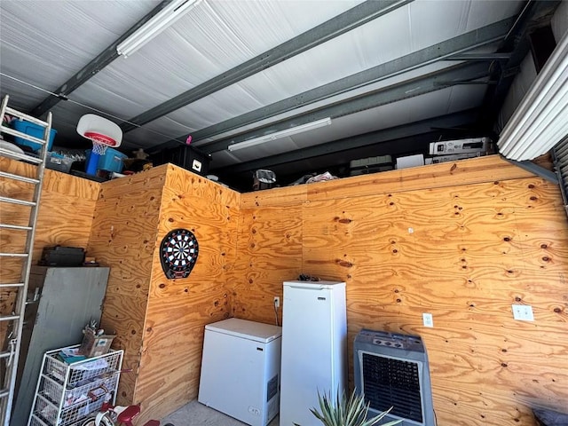 clothes washing area featuring wood walls