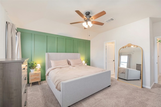 bedroom with ceiling fan, light colored carpet, and lofted ceiling