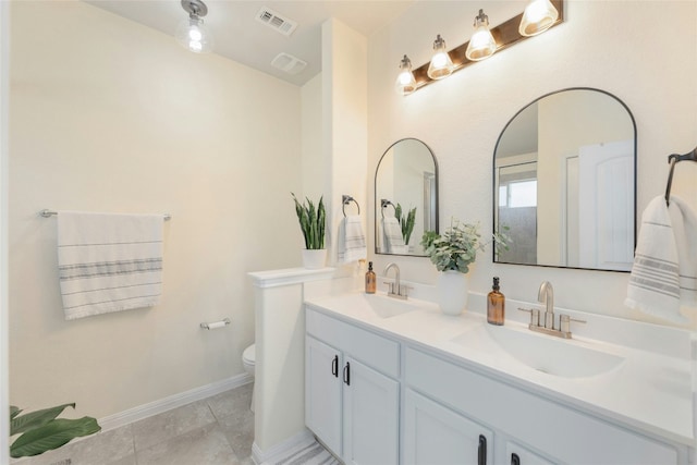 bathroom featuring tile patterned floors, vanity, and toilet