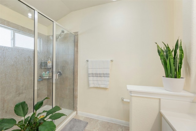 bathroom with vaulted ceiling, vanity, and an enclosed shower