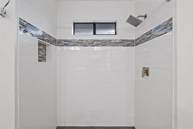 bathroom featuring a tile shower