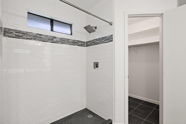 bathroom featuring a tile shower and tile patterned floors