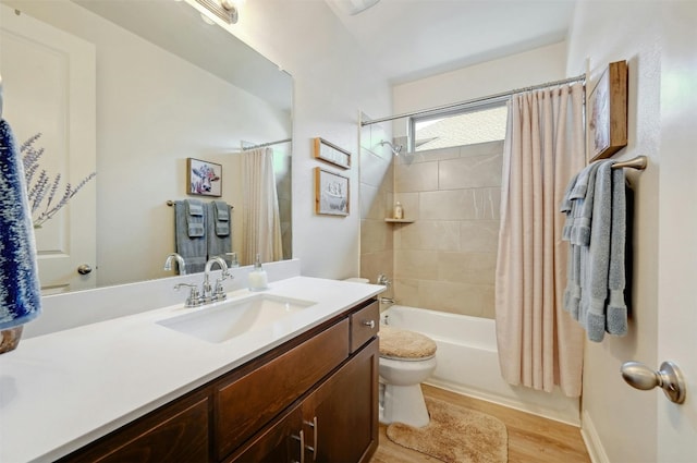 full bathroom featuring toilet, hardwood / wood-style floors, vanity, and shower / bath combo with shower curtain