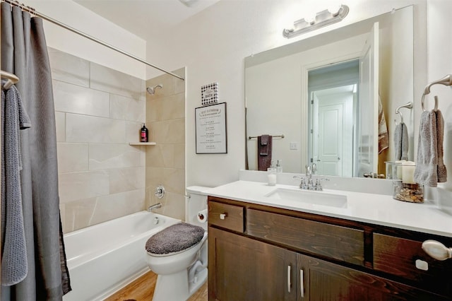 full bathroom with toilet, hardwood / wood-style floors, vanity, and shower / tub combo with curtain