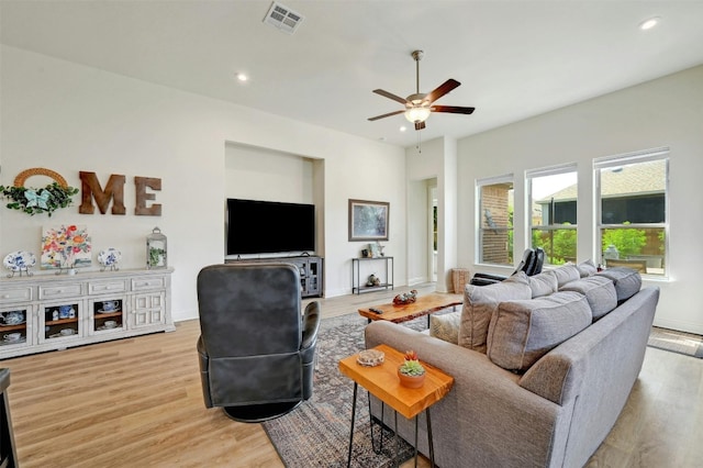 living room with light hardwood / wood-style floors and ceiling fan