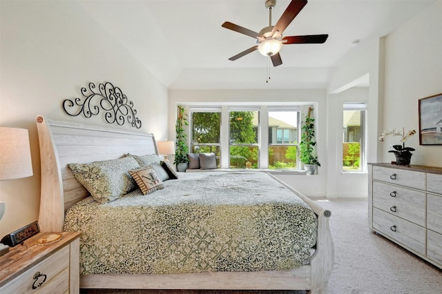 carpeted bedroom with vaulted ceiling and ceiling fan