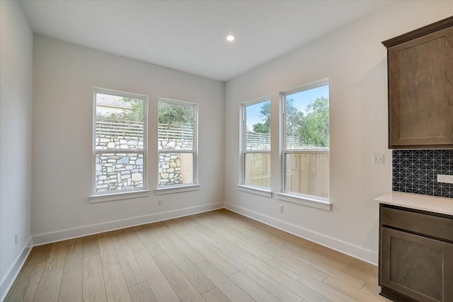 unfurnished dining area with light hardwood / wood-style floors