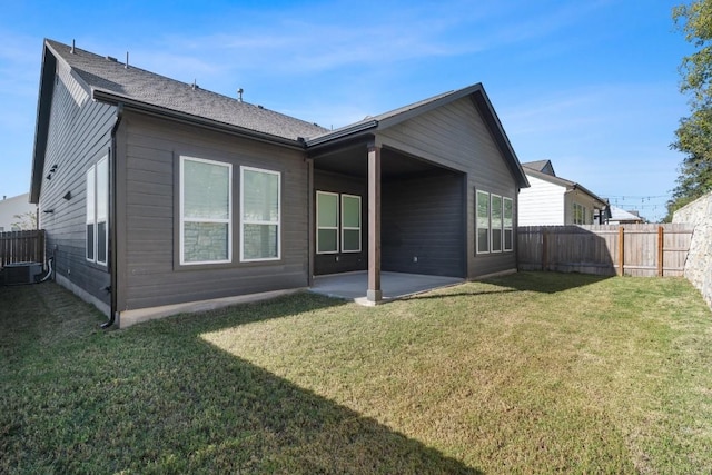 rear view of house with a yard and a patio