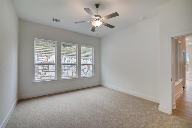 spare room with light carpet and ceiling fan